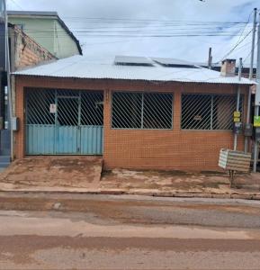 a brick building with a metal roof on a street at Pousadas JC 3 em Santarém in Santarém