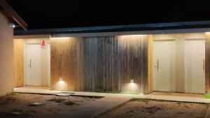 a row of three garage doors with lights on them at Dormis H35 in Ataliva Roca +2 photos