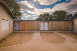 a garage with wooden doors and a cloudy sky at Dormis H35 in Ataliva Roca