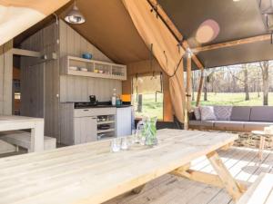 a wooden table in the kitchen of a caravan at De Limes Hoeve Safaritent A2 in Ingen