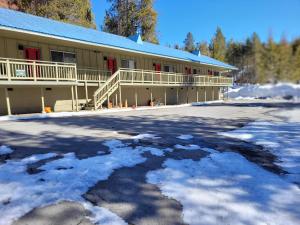 a building with a lot of snow in front of it at The Tamarack Lodge in Lakeshore