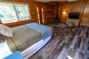 a bedroom with a bed and a television in it at The Tamarack Lodge in Lakeshore