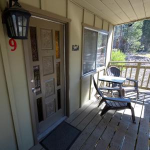 a porch with a table and a chair on it at The Tamarack Lodge in Lakeshore