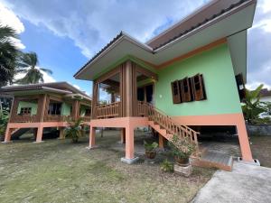 a house with a green and orange at Srisook House in Ko Phangan +10 photos