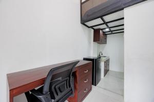 a kitchen with a wooden desk and a sink at Urbanview TeBeYe Syariah UNS Solo in Solo