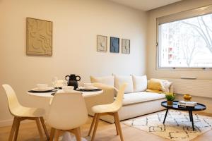 a living room with a table and a couch at Le Rhône - Aux Charmes Lyonnais ' in Lyon