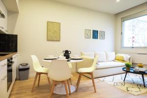a kitchen and living room with a table and chairs at Le Rhône - Aux Charmes Lyonnais ' in Lyon