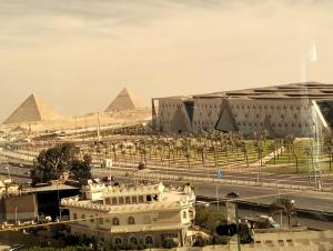 a view of the pyramids of giza and a building at Giza Pyramids& GYM View in Cairo