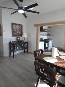 a dining room with a ceiling fan and a table at Twin Nest Duplex in Irving