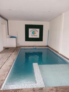 a large swimming pool in a room at Depto 09 Condominio Totoras in Federación