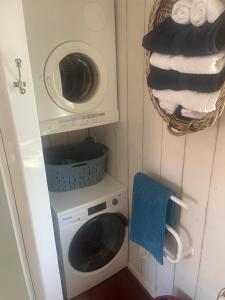 a laundry room with a washer and a washing machine at Bosuns Locker in Auckland