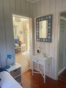 a bathroom with a sink and a mirror on the wall at Bosuns Locker in Auckland