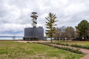 a building with a tower in a park at Studios near Beach in Balatonfoeldvar 18525 in Balatonföldvár
