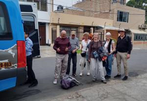 a group of people standing next to a bus at Hostal Donde Alberto in Trujillo