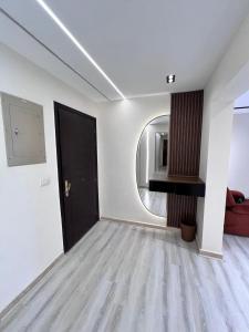 a living room with a black door and a mirror at Duplex villa in Beverly Hills in Sheikh Zayed +2 photos