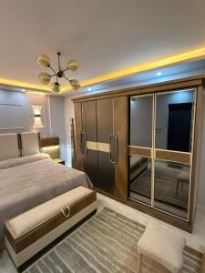 a bedroom with a large bed with a large window at Duplex villa in Beverly Hills in Sheikh Zayed