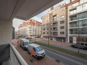 a view of two cars parked on a city street at Knokke City Centre Apartment for 6 in Knokke-Heist