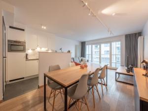 a kitchen and dining room with a table and chairs at Knokke City Centre Apartment for 6 in Knokke-Heist