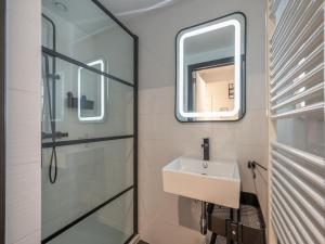 a bathroom with a sink and a mirror at Knokke City Centre Apartment for 6 in Knokke-Heist +30 photos