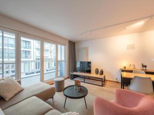 a living room with a couch and a table at Knokke City Centre Apartment for 6 in Knokke-Heist