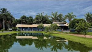a house with a pond in front of it at Pousada Paraiso valle verde in Estivado