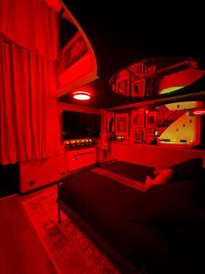 a bedroom with red lighting and a bed in it at Le 1920- Spa & Sauna privé- Love Room in Le Havre
