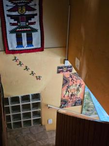 a room with a wall with paintings on the wall at Hostel Yellow House MG in Itamonte +78 photos