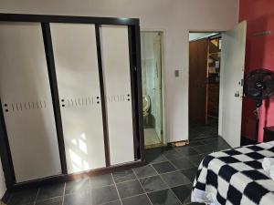a room with sliding glass doors in a bedroom at Hostel Yellow House MG in Itamonte