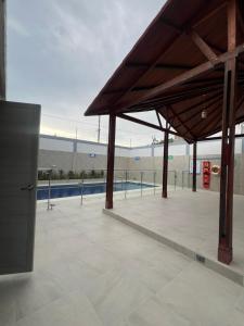 a building with a pavilion with a pool in the background at Serenity House in Santa Marta +1 photo