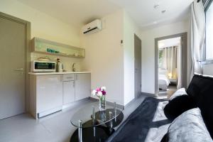 un soggiorno con un divano e un tavolo di vetro di Dizengoff Inn Apartments a Tel Aviv