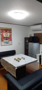 a kitchen with a table with a white table cloth at 桜庵 sakura an in Hatsukaichi
