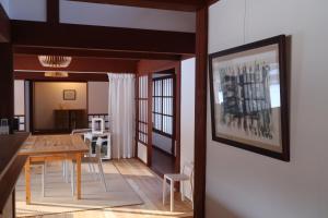 a dining room and living room with a table and chairs at Essai B&B - Quiet Village Retreat in Gokayama, near Shirakawa-go in Nanto