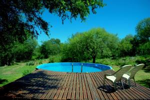two chairs sitting on a deck next to a pool at Habitaciones individuales o Dobles en La Llave in San Javier