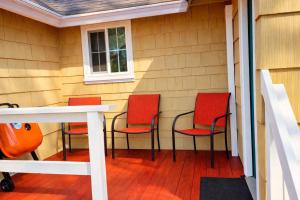 four chairs and a table on a porch at Siltcoos Station in Siltcoos