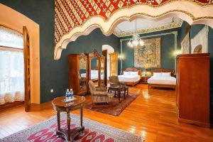 a large room with two beds and a table in it at La Casa de la Marquesa in Querétaro