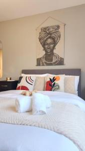 a bedroom with a bed with a bust of a woman at Urban Retreat - Leeds City Centre - Sleeps 4 in Central Station
