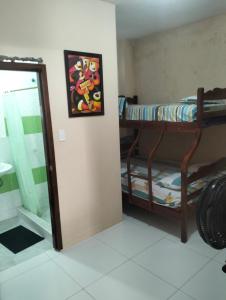 a room with two bunk beds next to a window at PAULIN Surf in Montañita