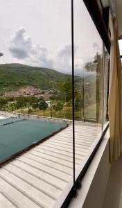 a view of a swimming pool from a window at Alojamiento Jaén in Jaén