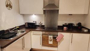 a kitchen with a sink and a stove top oven at Urban Retreat - Leeds City Centre - Sleeps 4 in Central Station +26 photos