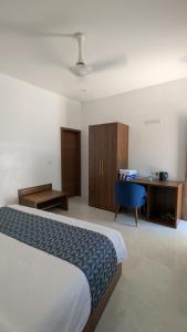 a hotel room with a bed and a desk at Luma Boutique Hotel Omadhoo in Omadhoo