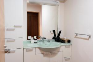 a bathroom with a sink and a mirror at Kaitan雲津 in Matsue +12 photos