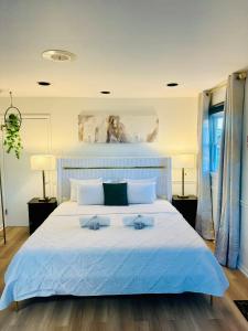 a bedroom with a large white bed with two pillows at The Blue House in Dover