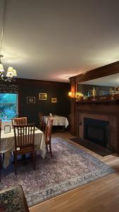 a dining room with a table and a fireplace at Oxford House Inn in Fryeburg