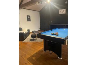 a living room with a pool table in it at Modern Chalet in Sougné-Remouchamps near Forest in Aywaille +17 photos
