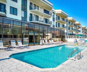 a swimming pool in front of a building at Bright Oceanfront 2BR Condo Balcony, King Bed & Parking in Ocean City