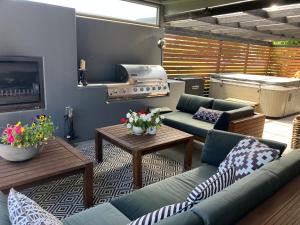 a living room with a couch and a stove at Maples on Harewood in Christchurch
