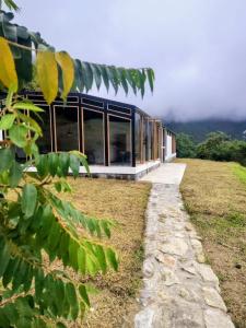 a glass house on a hill with a view at Domo Fengari in Pululahua