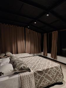 a large bed in a room with curtains at Domo Fengari in Pululahua +14 photos