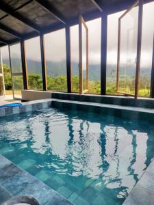 a swimming pool with a view of the mountains at Domo Fengari in Pululahua