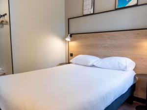 a bedroom with a large white bed with two pillows at Ibis Agen Centre - Rénové en 2026 in Agen +39 photos